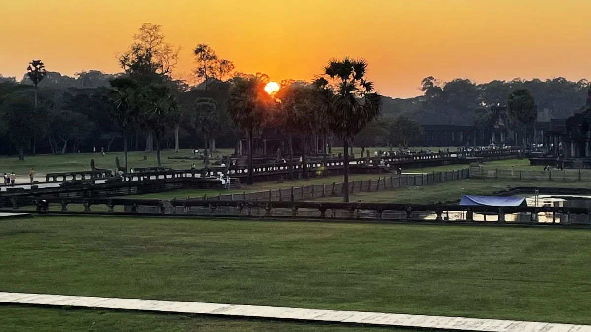 Sun rising over the Angkor park landscape in early morning light