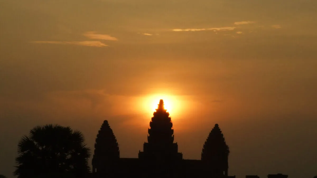 Silhouette of Angkor Wat at sunrise with the sun rising behind the towers